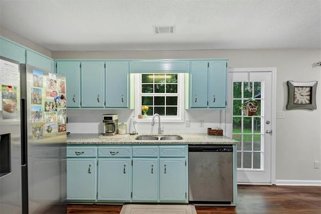 1050 Birdseye Vw, Locust Grove, GA 30248 - kitchen featuring appliances with stainless steel finishes, blue cabinetry, plenty of natural light, and dark wood-style floors