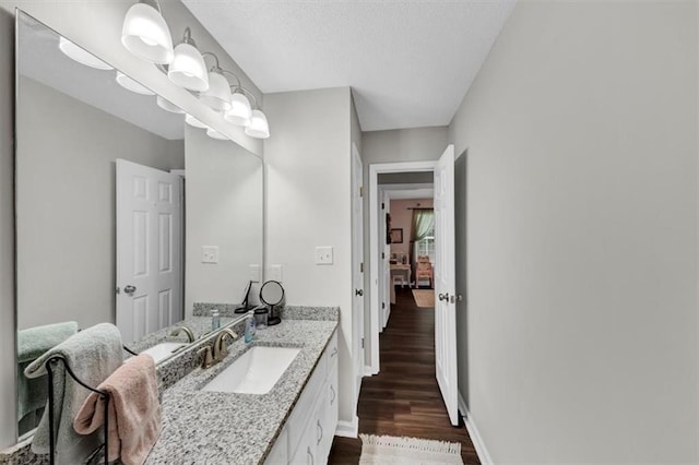 1050 Birdseye Vw, Locust Grove, GA 30248 - bathroom with wood finished floors, vanity, and a textured ceiling