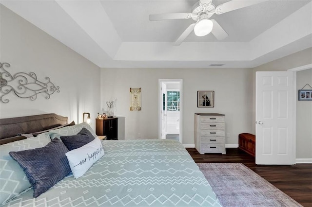 1050 Birdseye Vw, Locust Grove, GA 30248 - bedroom with a raised ceiling, wood finished floors, and a ceiling fan