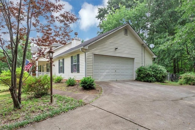 1050 Birdseye Vw, Locust Grove, GA 30248 - view of home's exterior with driveway, a garage, and a chimney