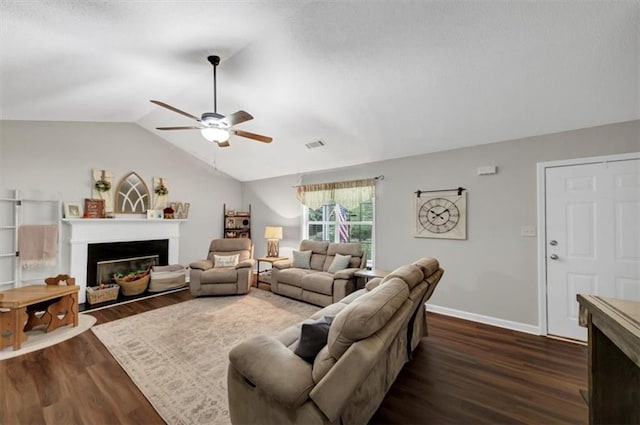 1050 Birdseye Vw, Locust Grove, GA 30248 - living room with a glass covered fireplace, a ceiling fan, dark wood-style floors, and lofted ceiling
