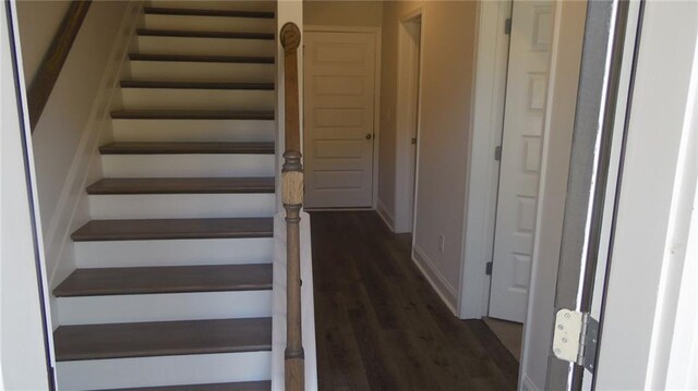 stairs featuring dark wood-type flooring