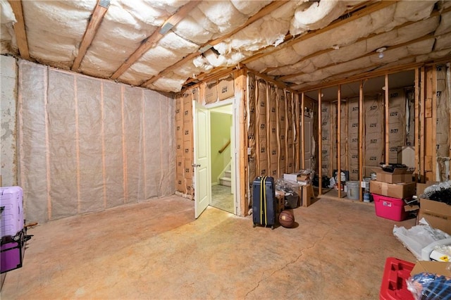 unfinished basement featuring stairway