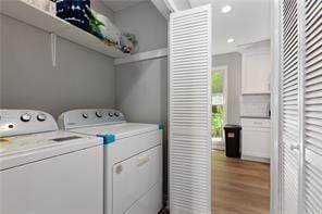 4406 Idlewood Ln, Tucker, GA 30084 - clothes washing area with independent washer and dryer, light wood-style floors, and recessed lighting