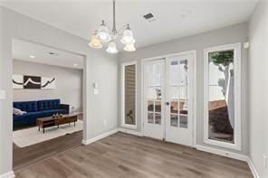 4406 Idlewood Ln, Tucker, GA 30084 - dining space with french doors, wood finished floors, baseboards, and a chandelier