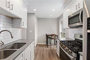 4406 Idlewood Ln, Tucker, GA 30084 - kitchen with stainless steel appliances, a sink, decorative backsplash, and recessed lighting