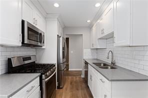 4406 Idlewood Ln, Tucker, GA 30084 - kitchen with stainless steel appliances, a sink, white cabinets, and recessed lighting