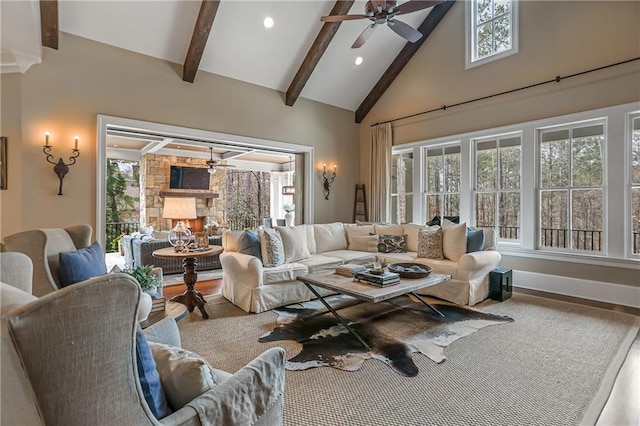 living room with baseboards, ceiling fan, beamed ceiling, high vaulted ceiling, and recessed lighting