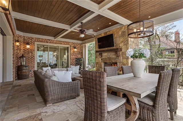 view of patio featuring an outdoor living space with a fireplace, outdoor dining area, and a ceiling fan