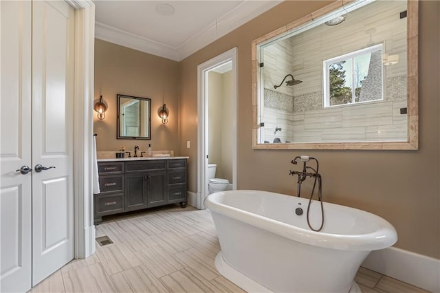 bathroom with toilet, vanity, ornamental molding, a soaking tub, and a tile shower