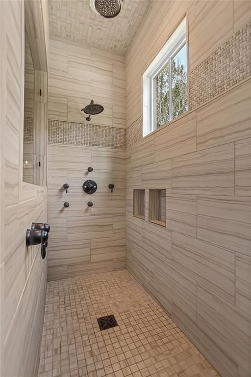 bathroom with a tile shower