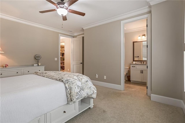 bedroom featuring light carpet, crown molding, ensuite bath, and baseboards