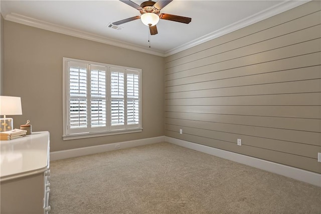 interior space with baseboards, carpet, visible vents, and crown molding