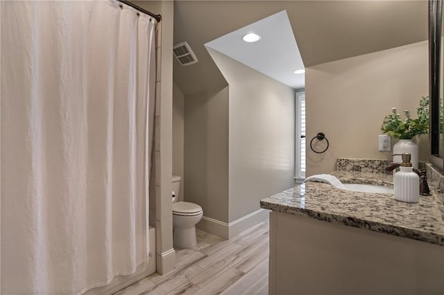 full bath with toilet, wood finished floors, visible vents, vanity, and baseboards