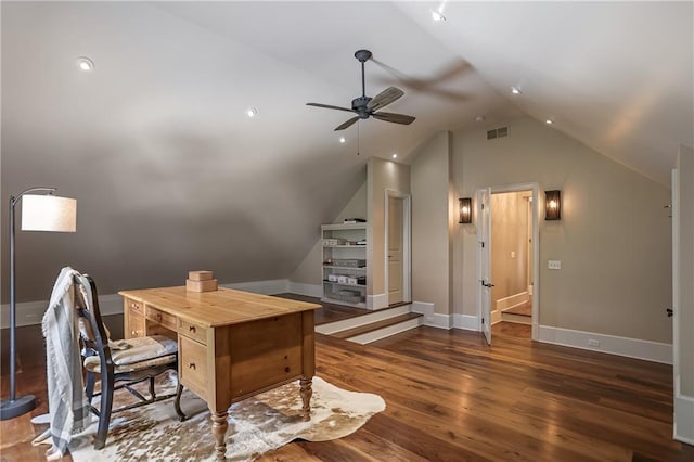 office space with dark wood-style flooring, a ceiling fan, visible vents, vaulted ceiling, and baseboards