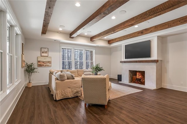 living room with dark wood-style floors, a fireplace with flush hearth, and baseboards