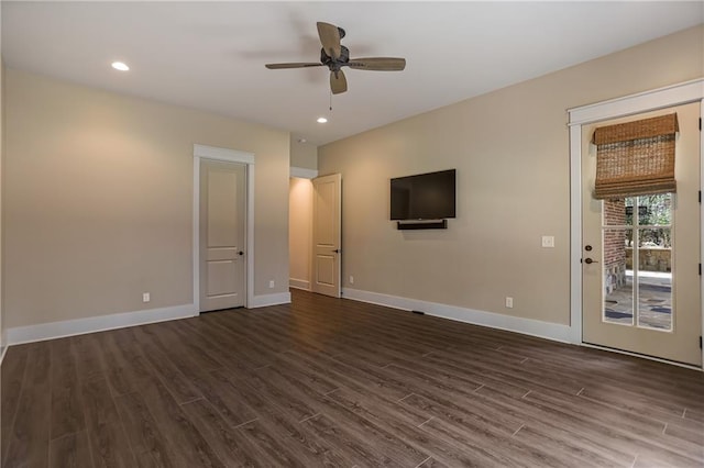 unfurnished living room with dark wood-style floors, baseboards, and a ceiling fan