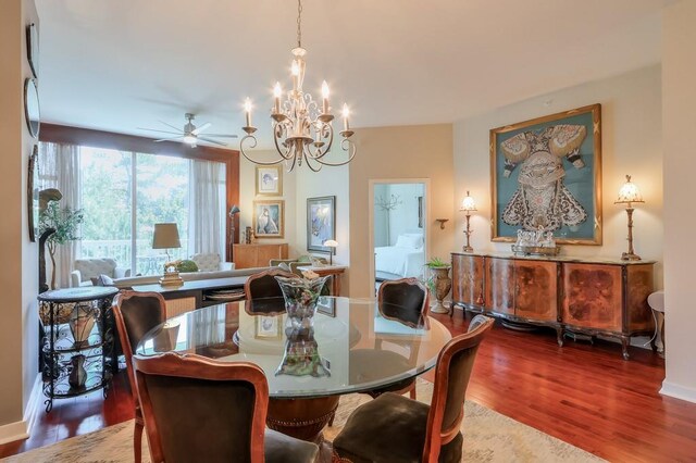 dining room with ceiling fan with notable chandelier and hardwood / wood-style floors