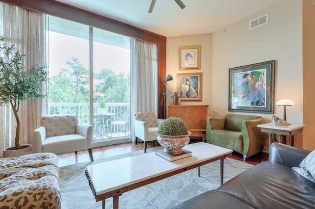 living room featuring ceiling fan and hardwood / wood-style flooring