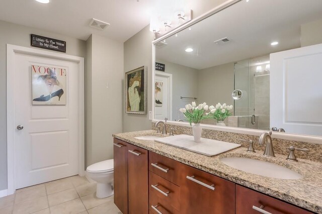 bathroom featuring an enclosed shower, tile patterned flooring, toilet, and vanity