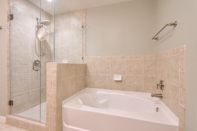 bathroom featuring shower with separate bathtub