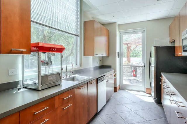 kitchen featuring sink, light tile patterned floors, and appliances with stainless steel finishes