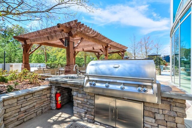 view of patio / terrace with area for grilling, an outdoor bar, and a pergola