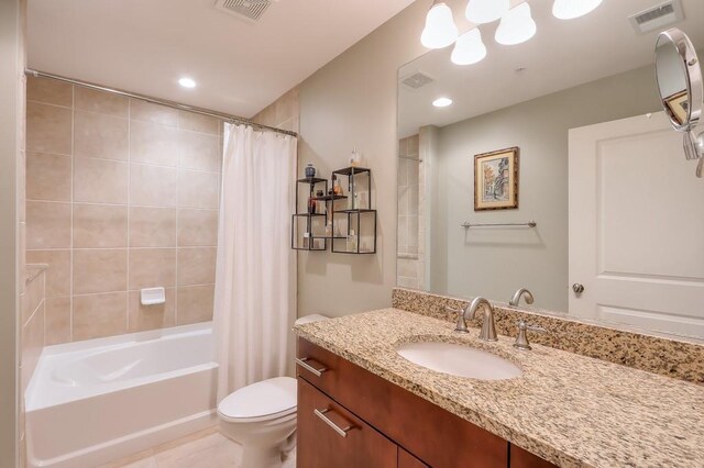 full bathroom featuring tile patterned flooring, vanity, toilet, and shower / bath combination with curtain