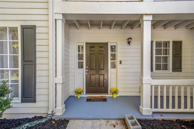 view of front of property featuring a balcony, a front lawn, and a garage