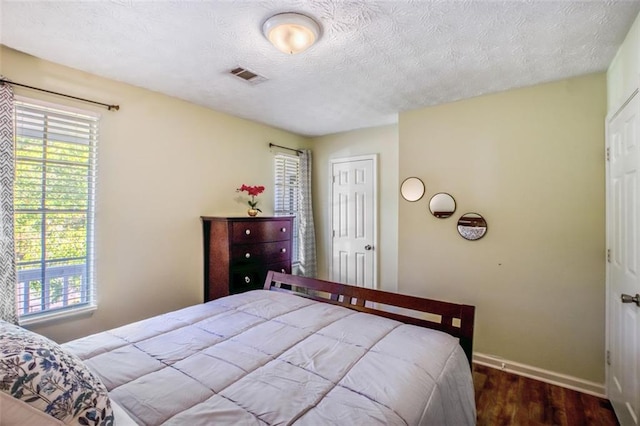 bathroom featuring vanity, a textured ceiling, and toilet