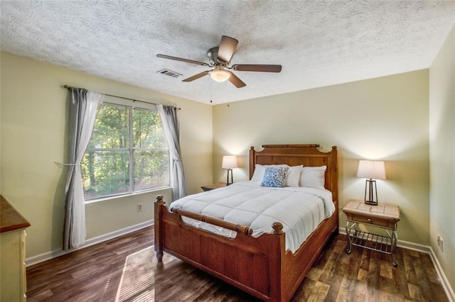 bedroom featuring dark hardwood / wood-style floors, lofted ceiling, and a textured ceiling