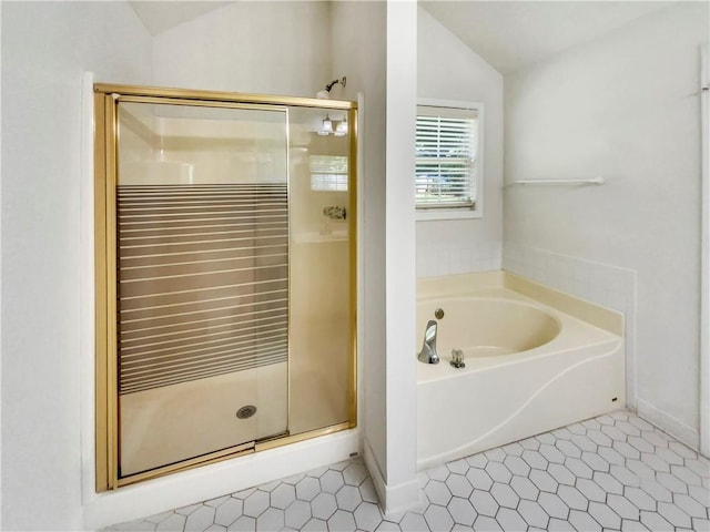 full bathroom with lofted ceiling, a shower stall, a bath, and tile patterned floors