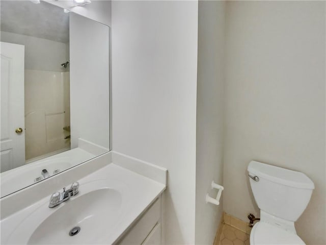 full bathroom with vanity, toilet, and walk in shower