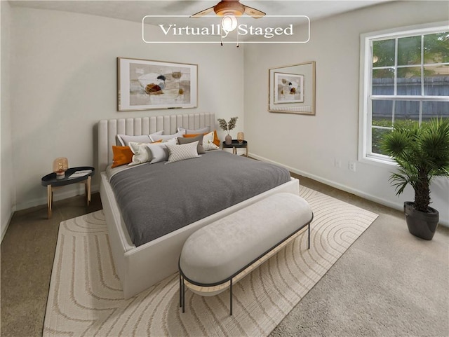 carpeted bedroom featuring radiator, baseboards, and a ceiling fan