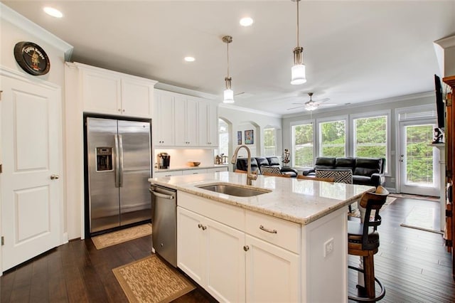 kitchen with ceiling fan, crown molding, appliances with stainless steel finishes, a sink, and dark wood-style floors