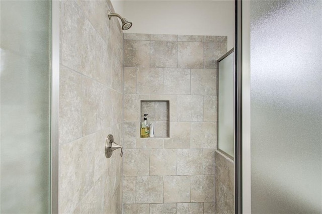 interior details featuring a stall shower