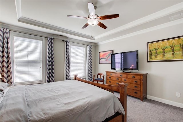 bedroom with light carpet, a raised ceiling, baseboards, visible vents, and ornamental molding