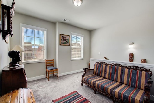 carpeted living room featuring baseboards and visible vents