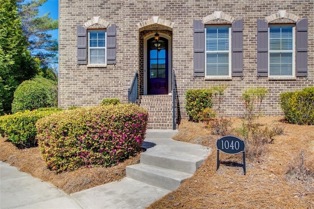 property entrance featuring brick siding