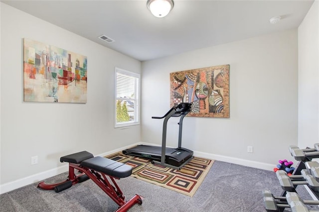 workout area with visible vents, carpet, and baseboards
