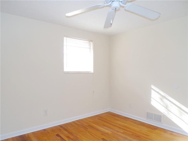 empty room featuring ceiling fan and wood-type flooring