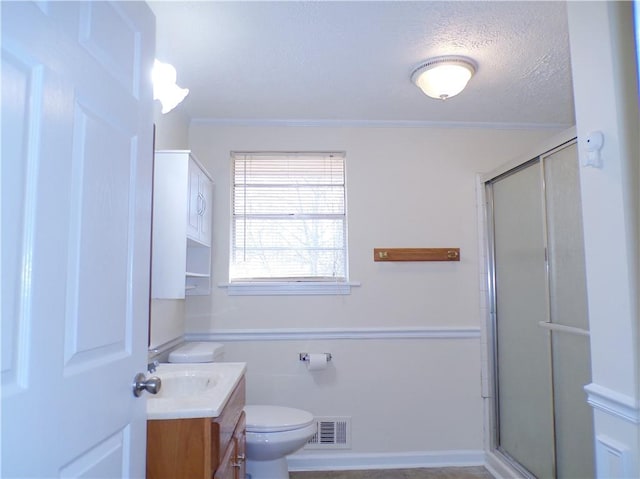 bathroom featuring vanity, toilet, and a shower with shower door