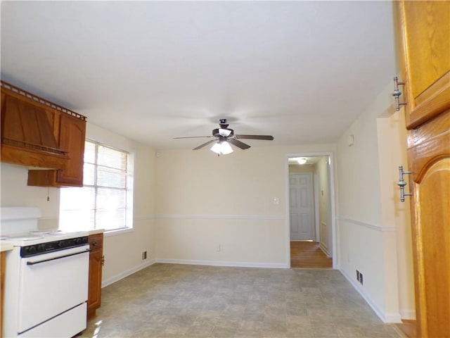 kitchen featuring white electric stove, custom range hood, and ceiling fan