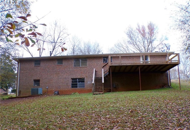 back of property with a yard, central air condition unit, and a deck