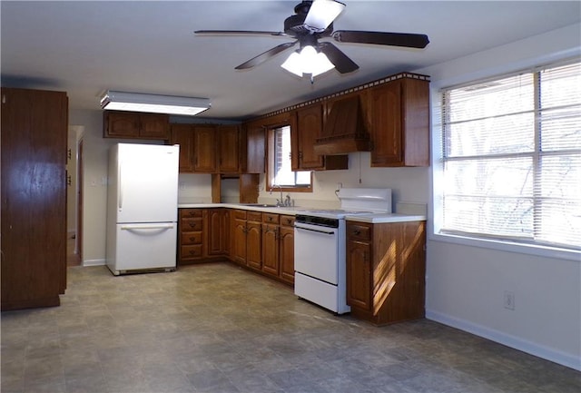 kitchen with sink, white appliances, custom exhaust hood, and ceiling fan