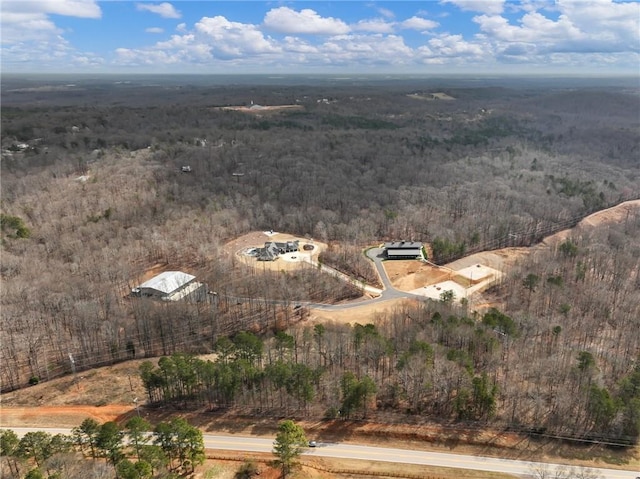 bird's eye view featuring a wooded view