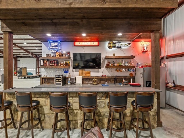 bar featuring wet bar and concrete flooring