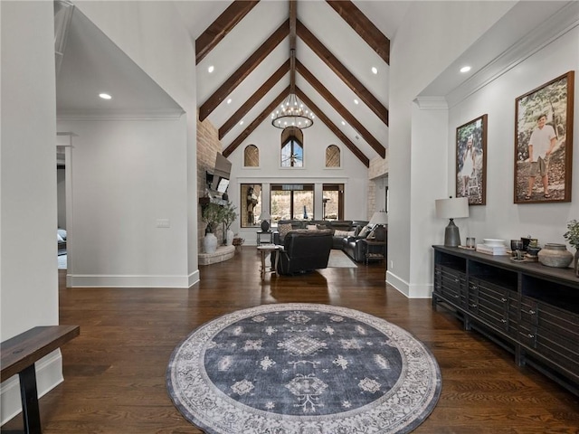 entryway with beam ceiling, high vaulted ceiling, an inviting chandelier, and wood finished floors