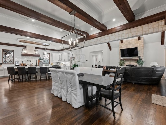 dining room featuring visible vents, beam ceiling, dark wood-type flooring, recessed lighting, and a large fireplace