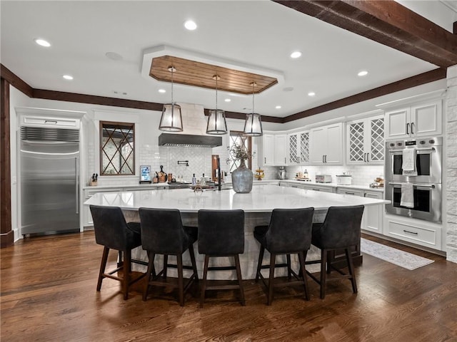 kitchen with dark wood finished floors, white cabinets, and appliances with stainless steel finishes